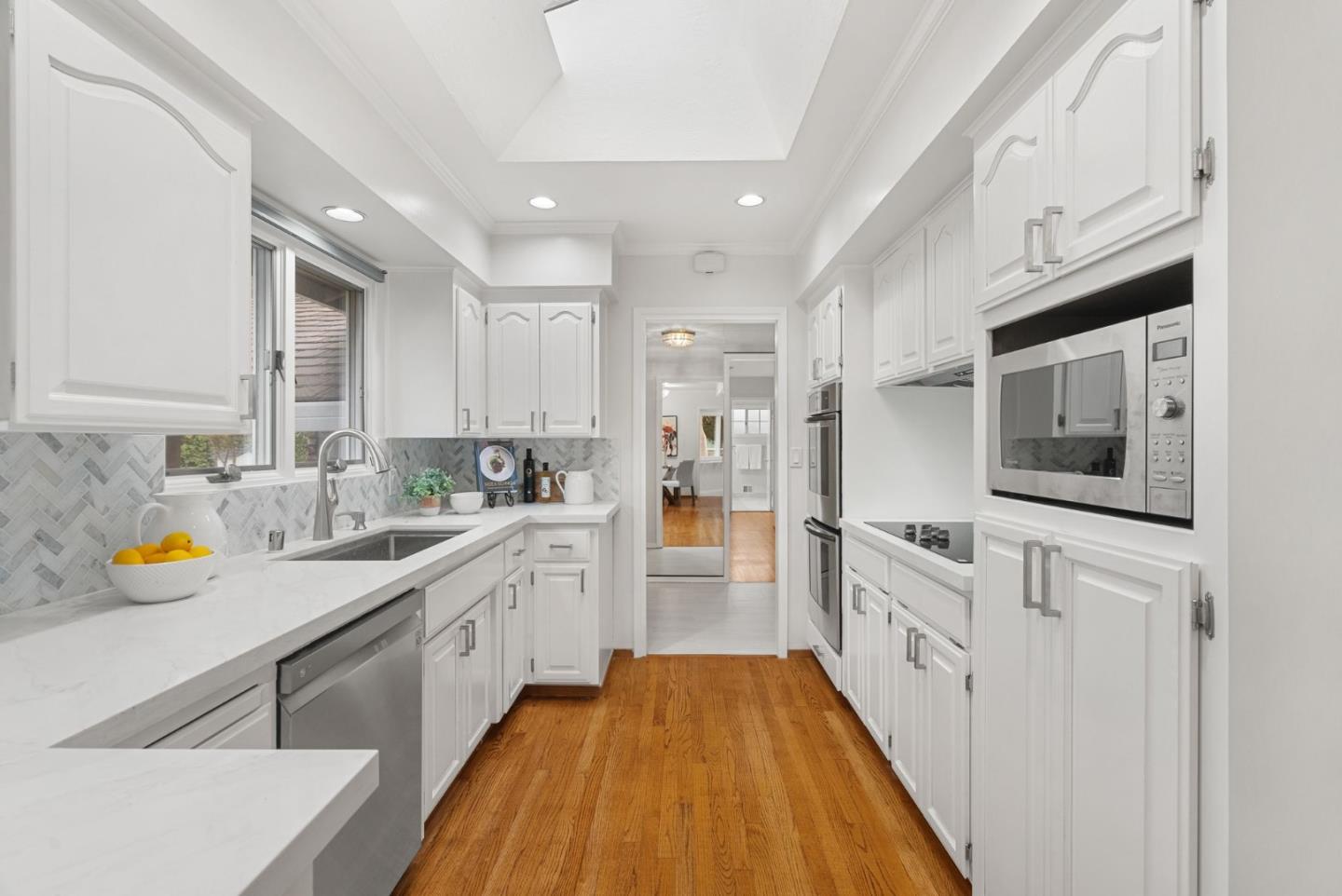 18765 Westview Drive Saratoga, CA 95070 - Photo 16 of 40 a large kitchen with stainless steel appliances granite countertop a lot of counter space and wooden floors
