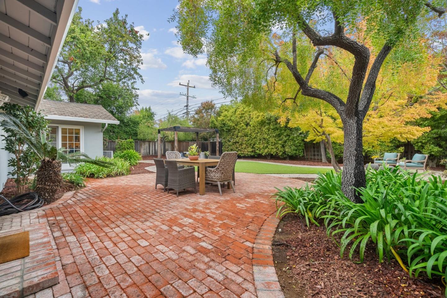 18765 Westview Drive Saratoga, CA 95070 - Photo 27 of 40 a view of a chair and tables in the patio with a yard
