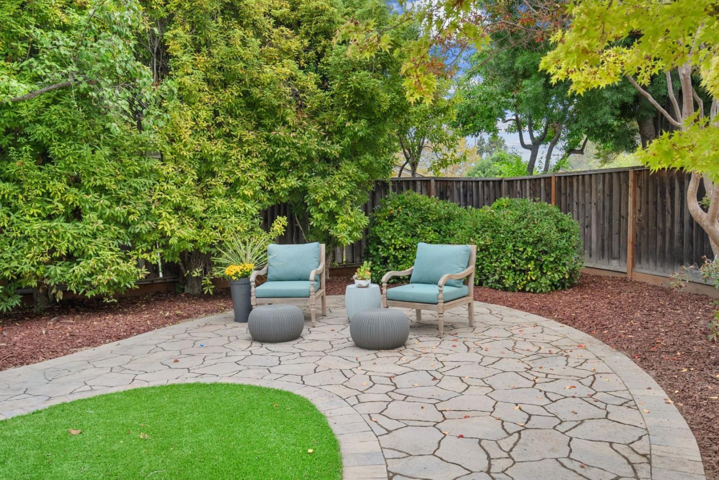 18765 Westview Drive Saratoga, CA 95070 - Photo 29 of 40 a view of a backyard with table and chairs potted plants and wooden fence