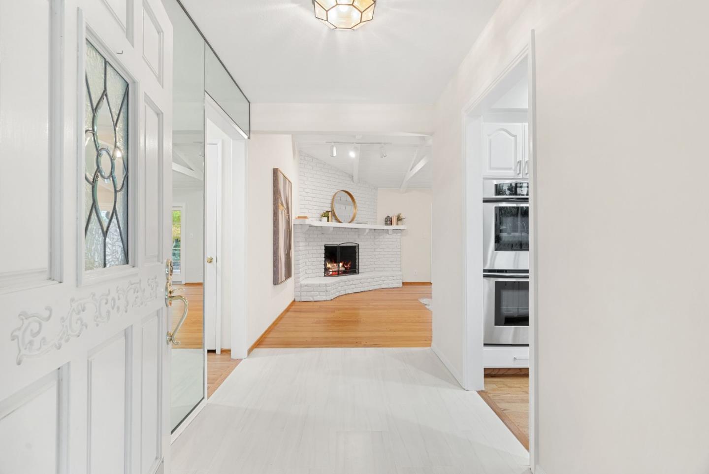 18765 Westview Drive Saratoga, CA 95070 - Photo 8 of 40 a view of a hallway with wooden floor and dining room