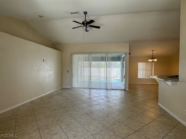 wooden floor in an empty room with a kitchen