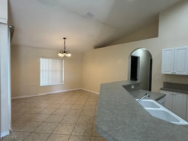 a kitchen with granite countertop a sink and stainless steel appliances