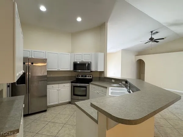 a bathroom with a granite countertop sink mirror vanity and toilet