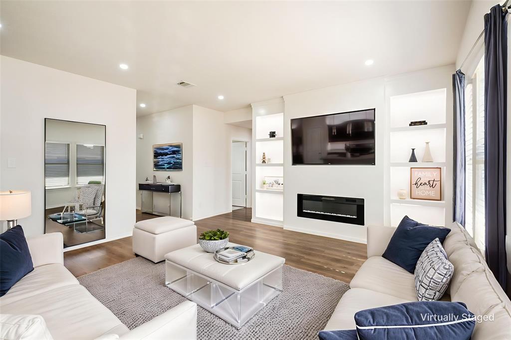 a living room with furniture a rug and a flat screen tv