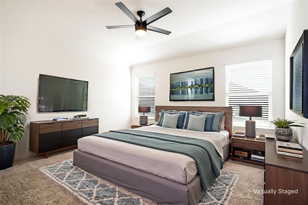 3104 Barzona Road Forney, TX 75126 - Photo 15 of 26 a bedroom with a large bed and a flat screen tv