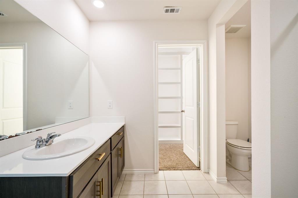 3104 Barzona Road Forney, TX 75126 - Photo 19 of 26 a bathroom with a sink and a mirror