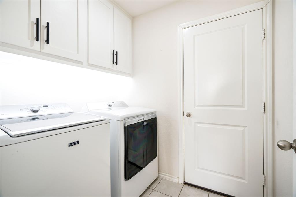 3104 Barzona Road Forney, TX 75126 - Photo 21 of 26 a utility room with cabinets washer and dryer