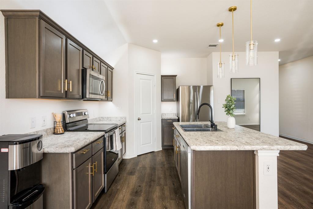 3104 Barzona Road Forney, TX 75126 - Photo 6 of 26 a kitchen with stainless steel appliances granite countertop a sink stove and refrigerator