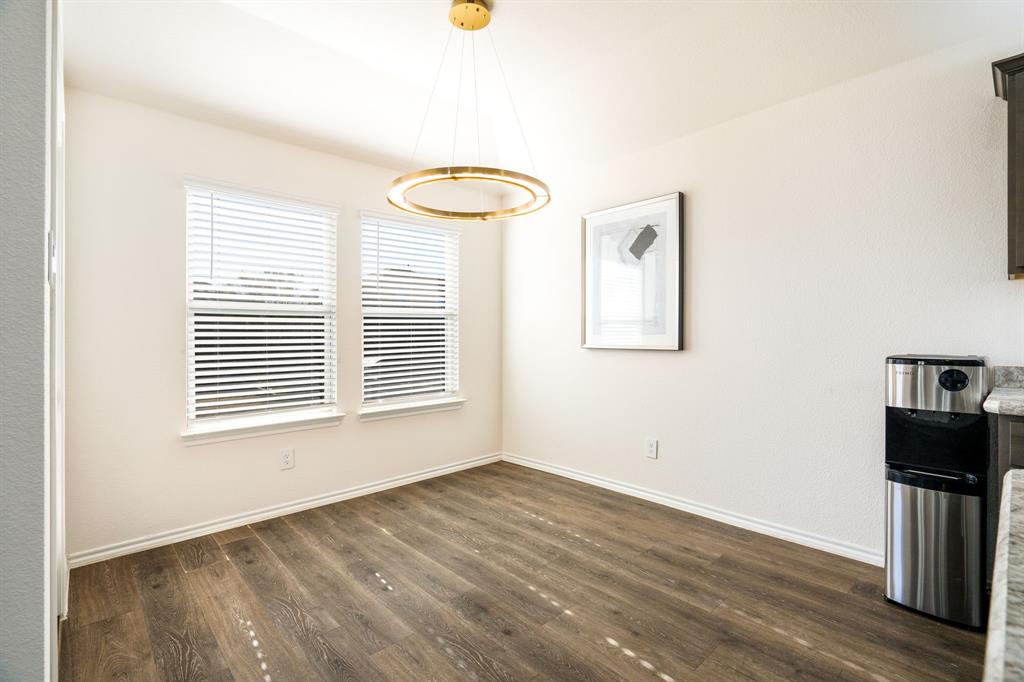 3104 Barzona Road Forney, TX 75126 - Photo 8 of 26 a view of an empty room with wooden floor and a window