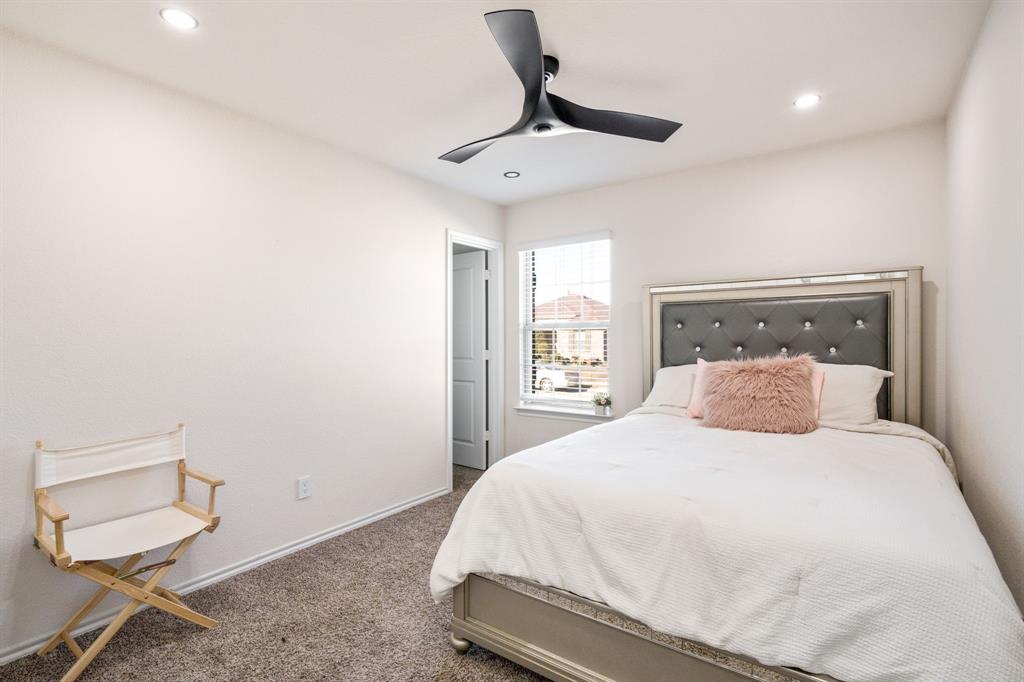 3104 Barzona Road Forney, TX 75126 - Photo 9 of 26 a bedroom with a bed and window