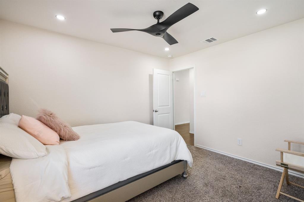 3104 Barzona Road Forney, TX 75126 - Photo 10 of 26 a bedroom with a bed and a ceiling fan