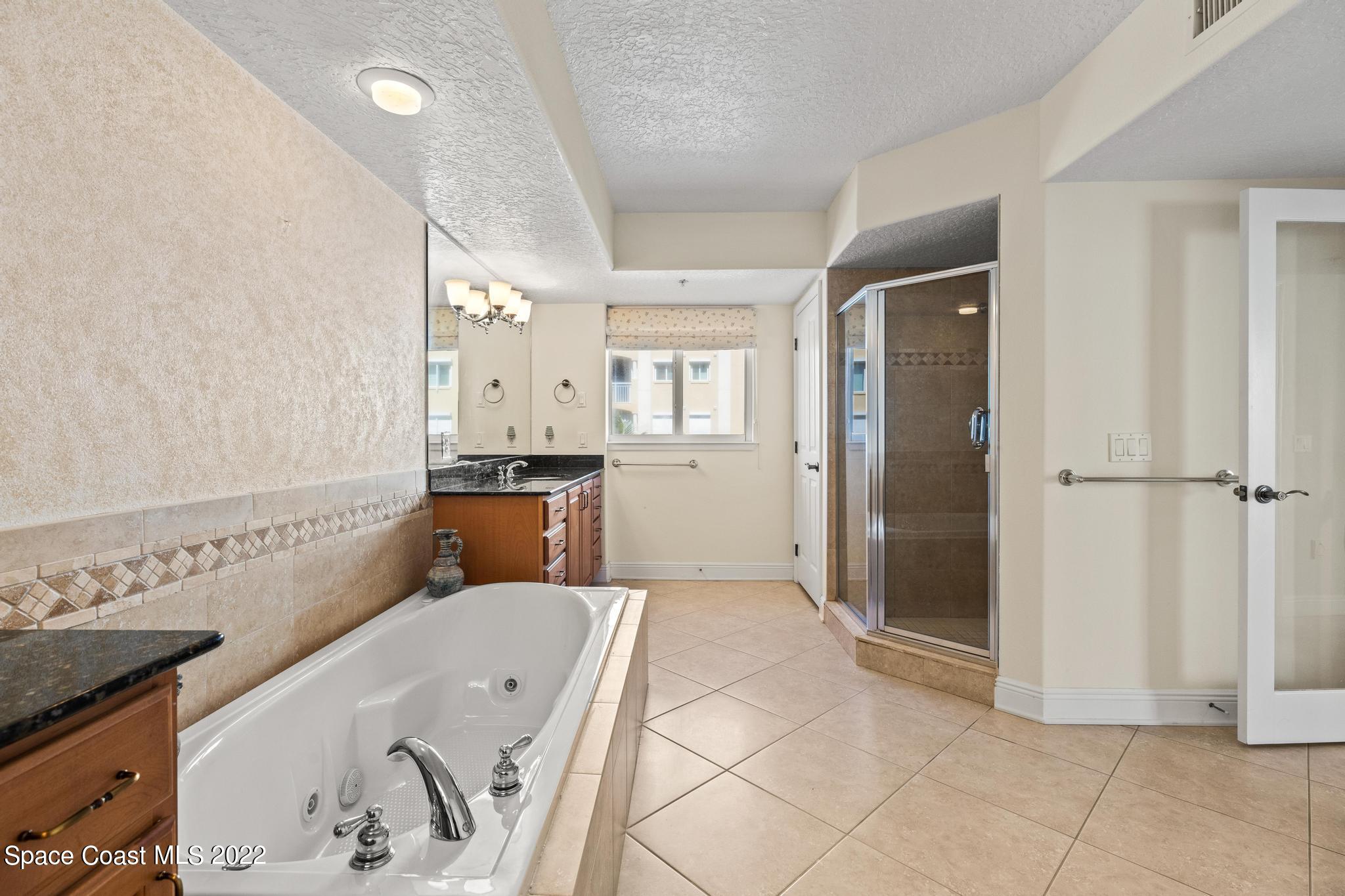 1095 Florida A1A, Unit 2301 Satellite Beach, FL 32937 - Photo 11 of 26 a spacious bathroom with a tub and shower