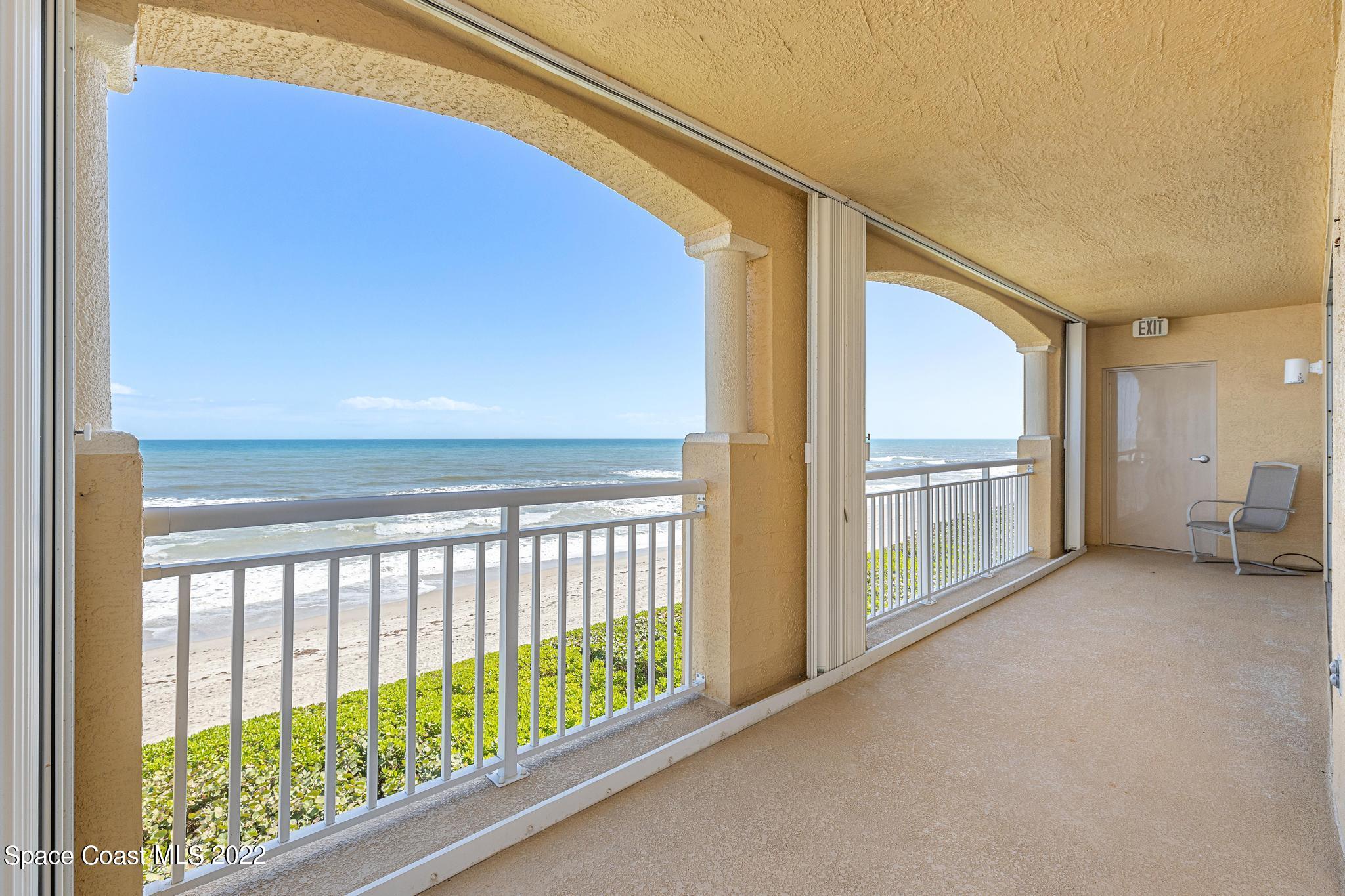 1095 Florida A1A, Unit 2301 Satellite Beach, FL 32937 - Photo 18 of 26 a view of a hallway with furniture and floor to ceiling window
