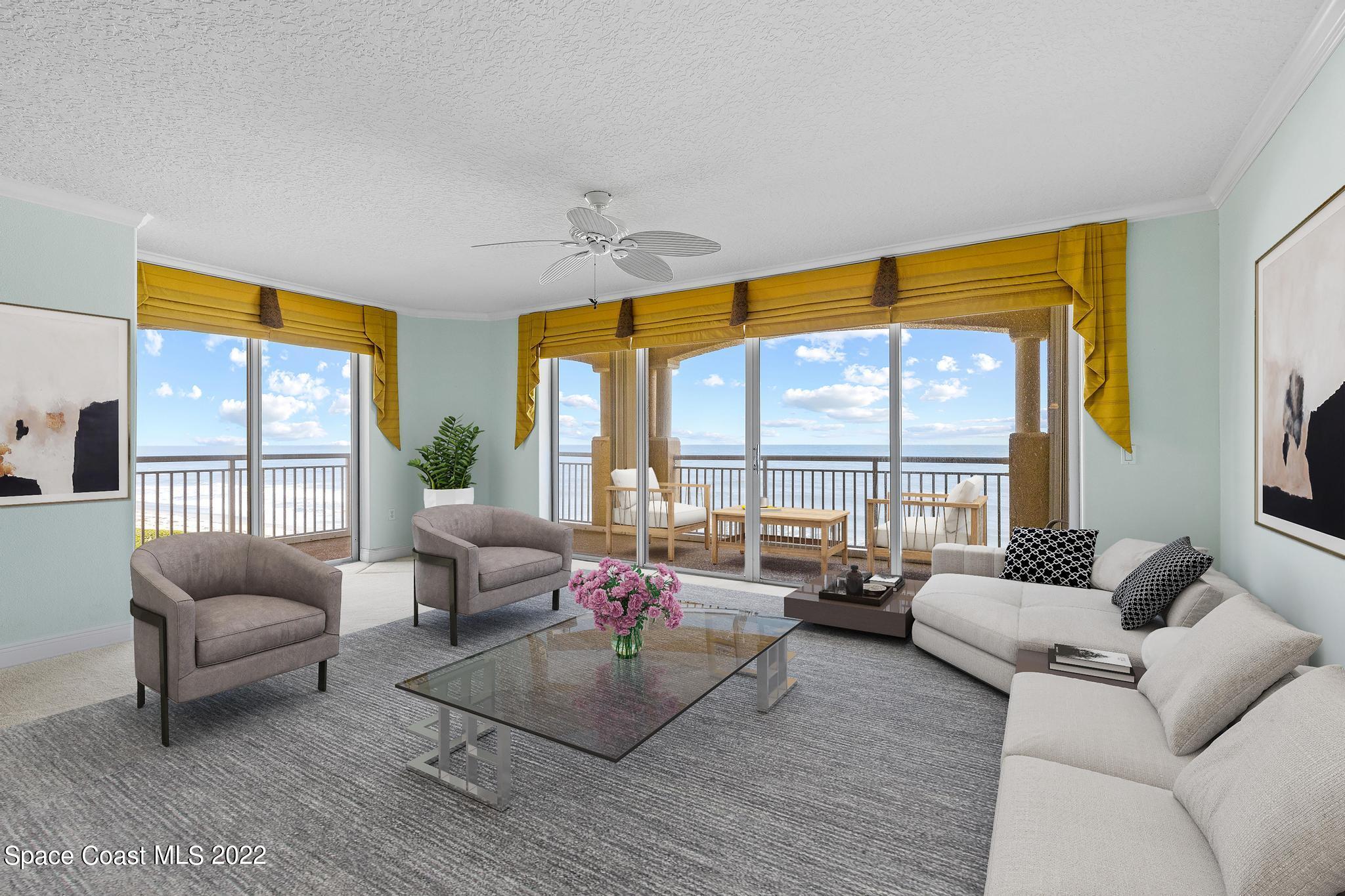 1095 Florida A1A, Unit 2301 Satellite Beach, FL 32937 - Photo 2 of 26 a living room with furniture and a large window