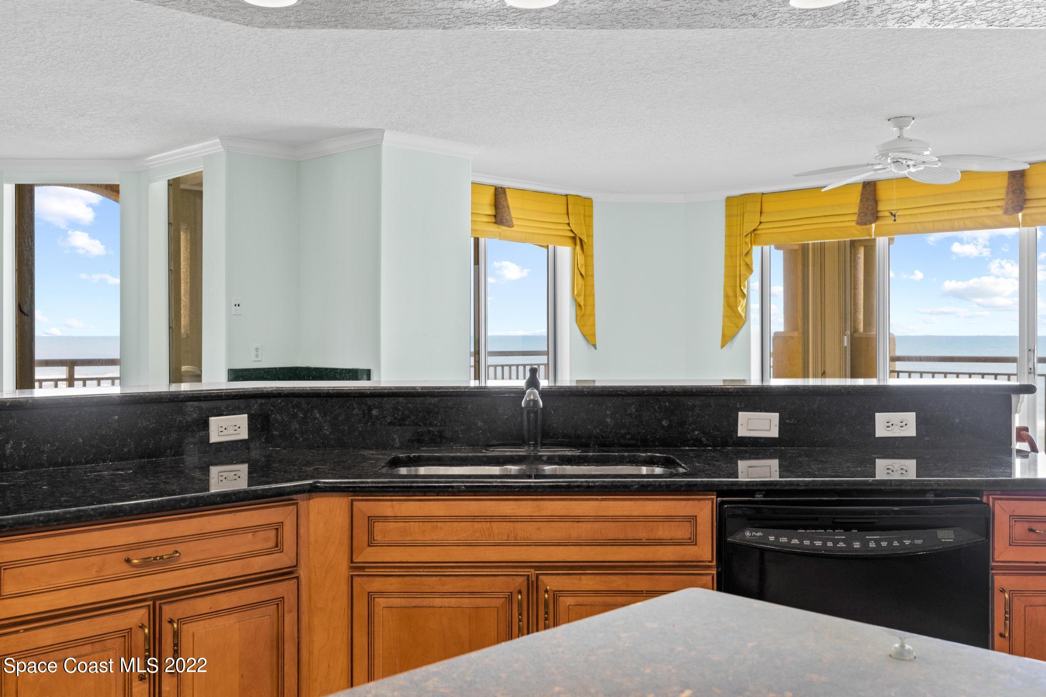 1095 Florida A1A, Unit 2301 Satellite Beach, FL 32937 - Photo 4 of 26 a kitchen with stainless steel appliances granite countertop a stove a sink and a granite countertops