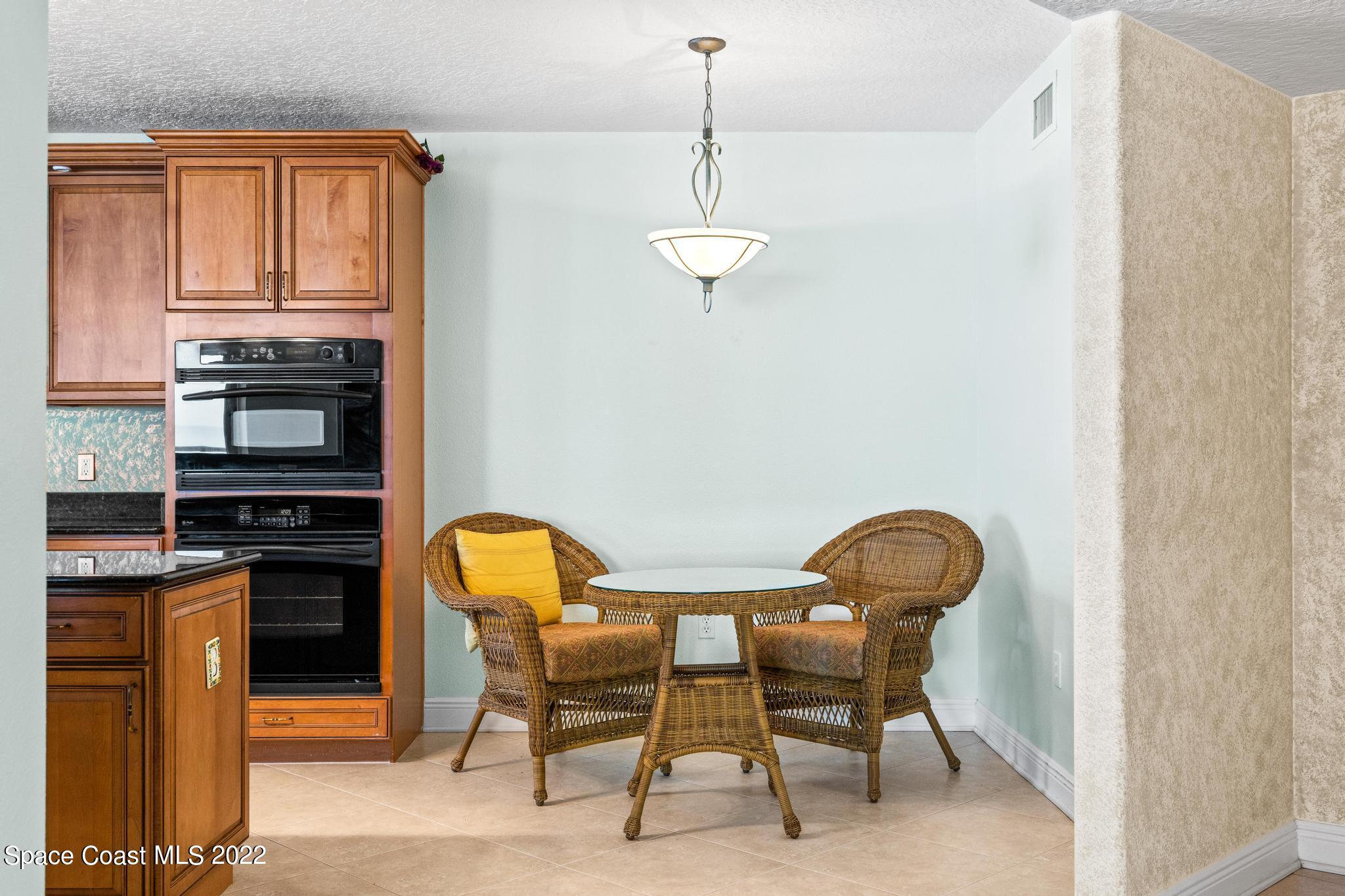1095 Florida A1A, Unit 2301 Satellite Beach, FL 32937 - Photo 6 of 26 a dining room with furniture and window
