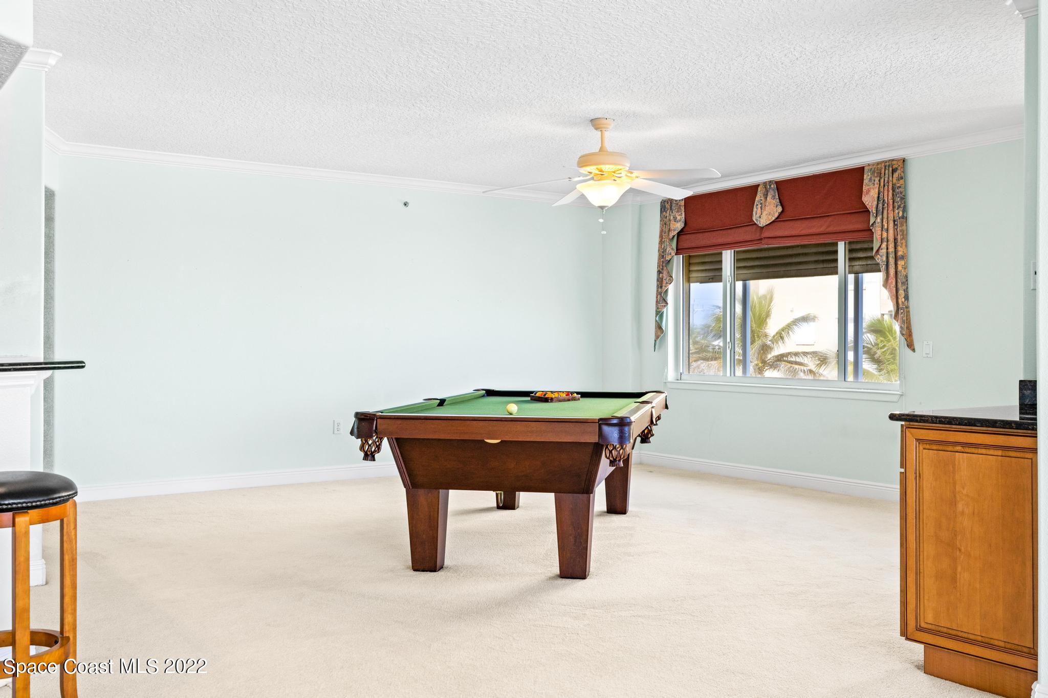 1095 Florida A1A, Unit 2301 Satellite Beach, FL 32937 - Photo 7 of 26 a room with a table and a window