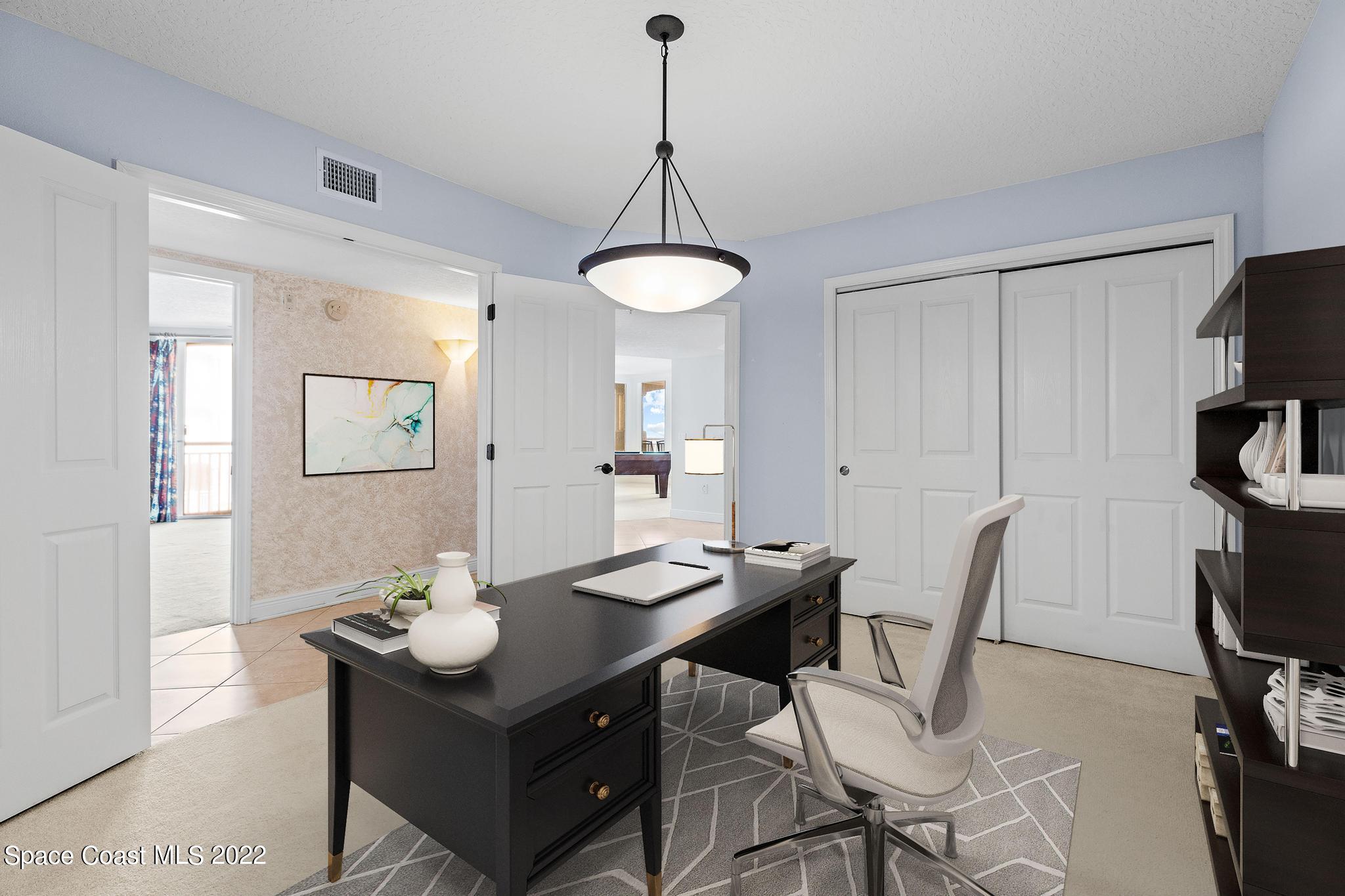 1095 Florida A1A, Unit 2301 Satellite Beach, FL 32937 - Photo 8 of 26 a view of a workspace with furniture and bathroom