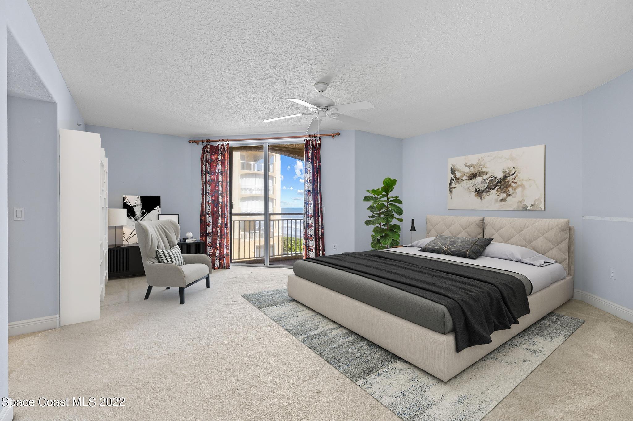 1095 Florida A1A, Unit 2301 Satellite Beach, FL 32937 - Photo 9 of 26 a spacious bedroom with a bed and large windows