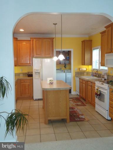 3504 Long Meadow Road Middletown, VA 22645 - Photo 22 of 28 a kitchen with stainless steel appliances granite countertop a stove a sink and a refrigerator