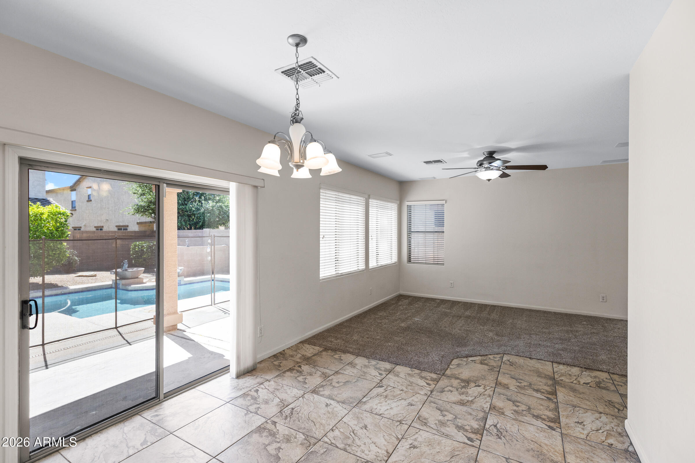3029 East Franklin Avenue Gilbert, AZ 85295 - Photo 11 of 38 a view of a livingroom with a chandelier fan and windows