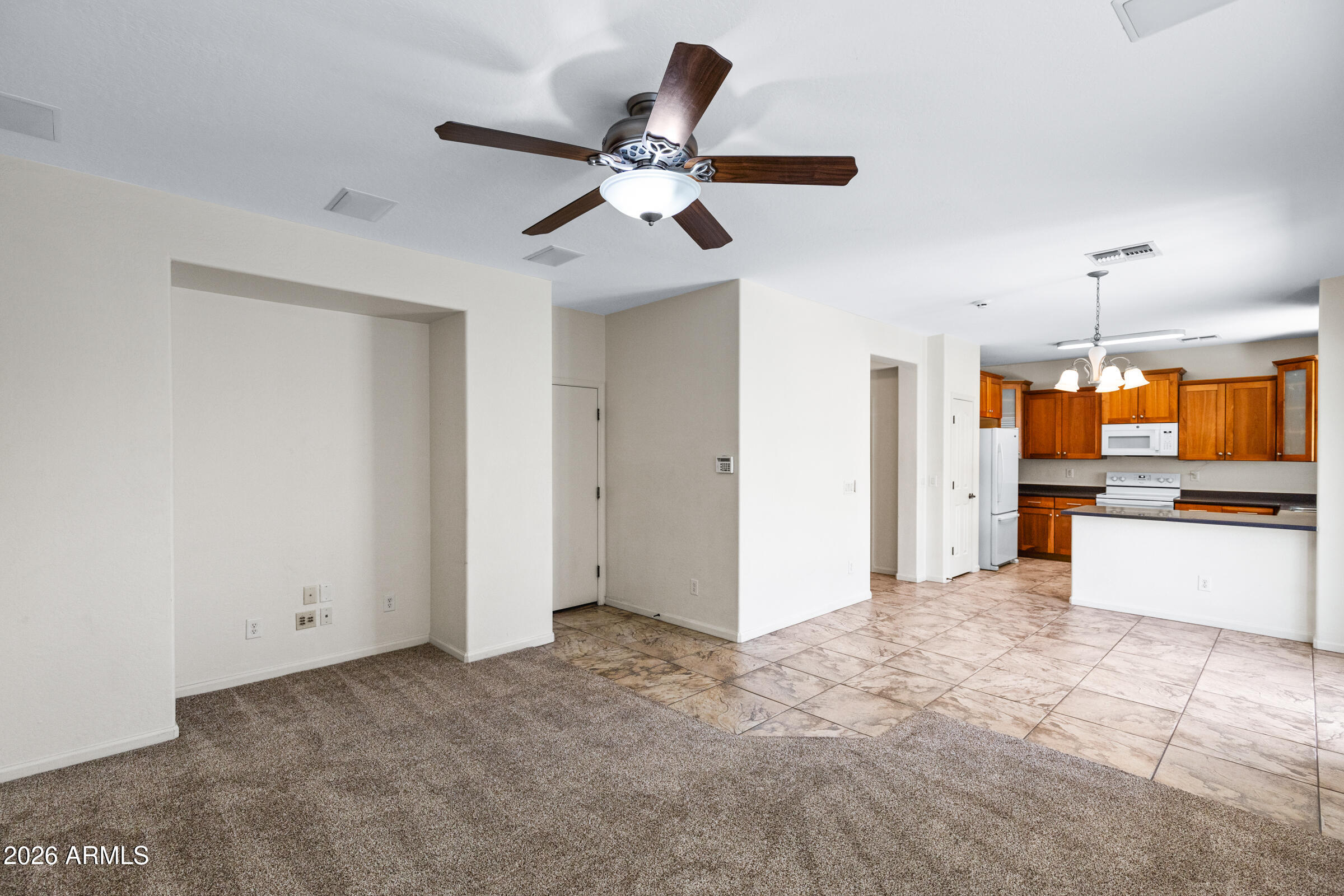 3029 East Franklin Avenue Gilbert, AZ 85295 - Photo 12 of 38 a view of a kitchen with a stove cabinets and a ceiling fan