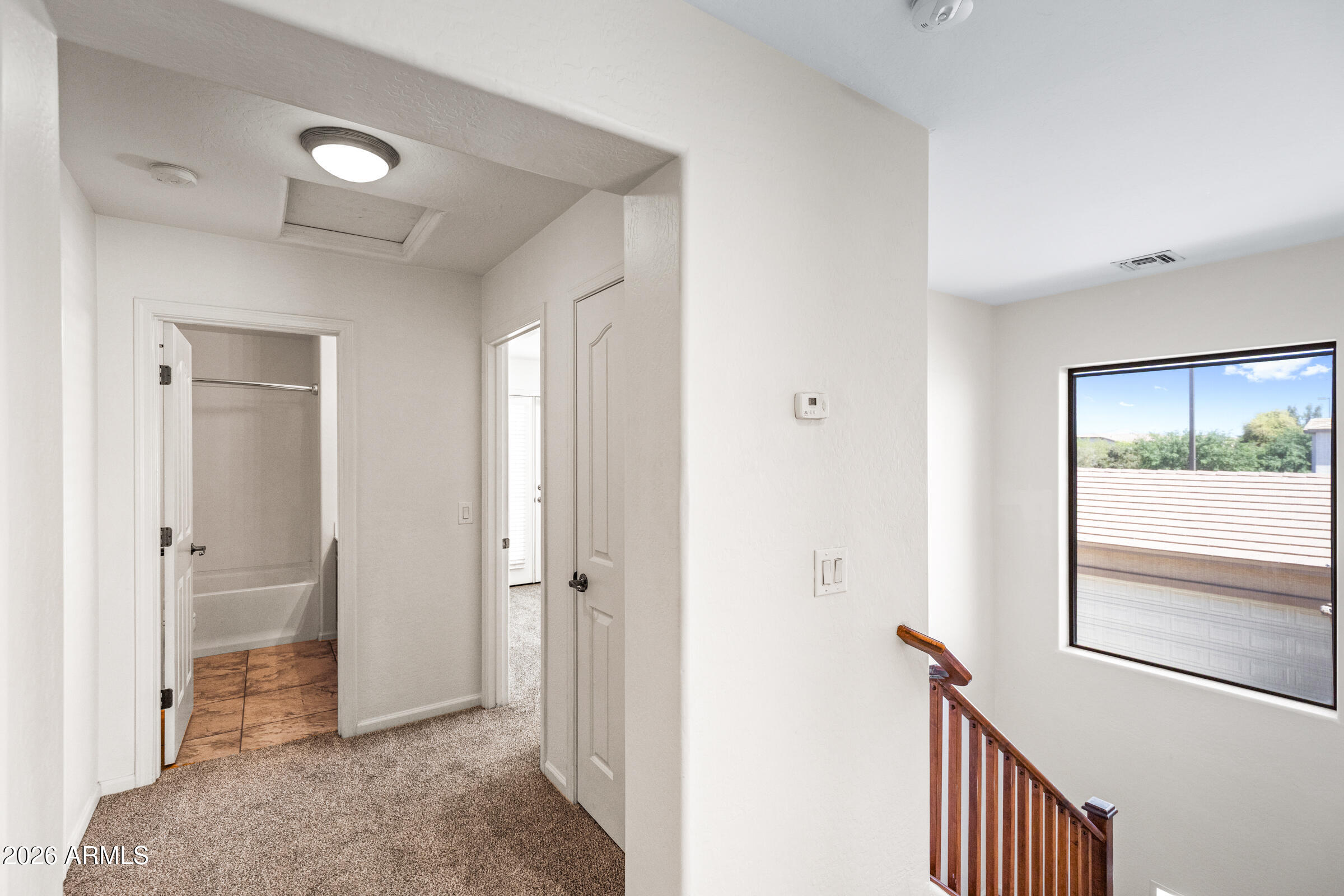 3029 East Franklin Avenue Gilbert, AZ 85295 - Photo 16 of 38 a view of a hallway with a livingroom and a bathroom with sink