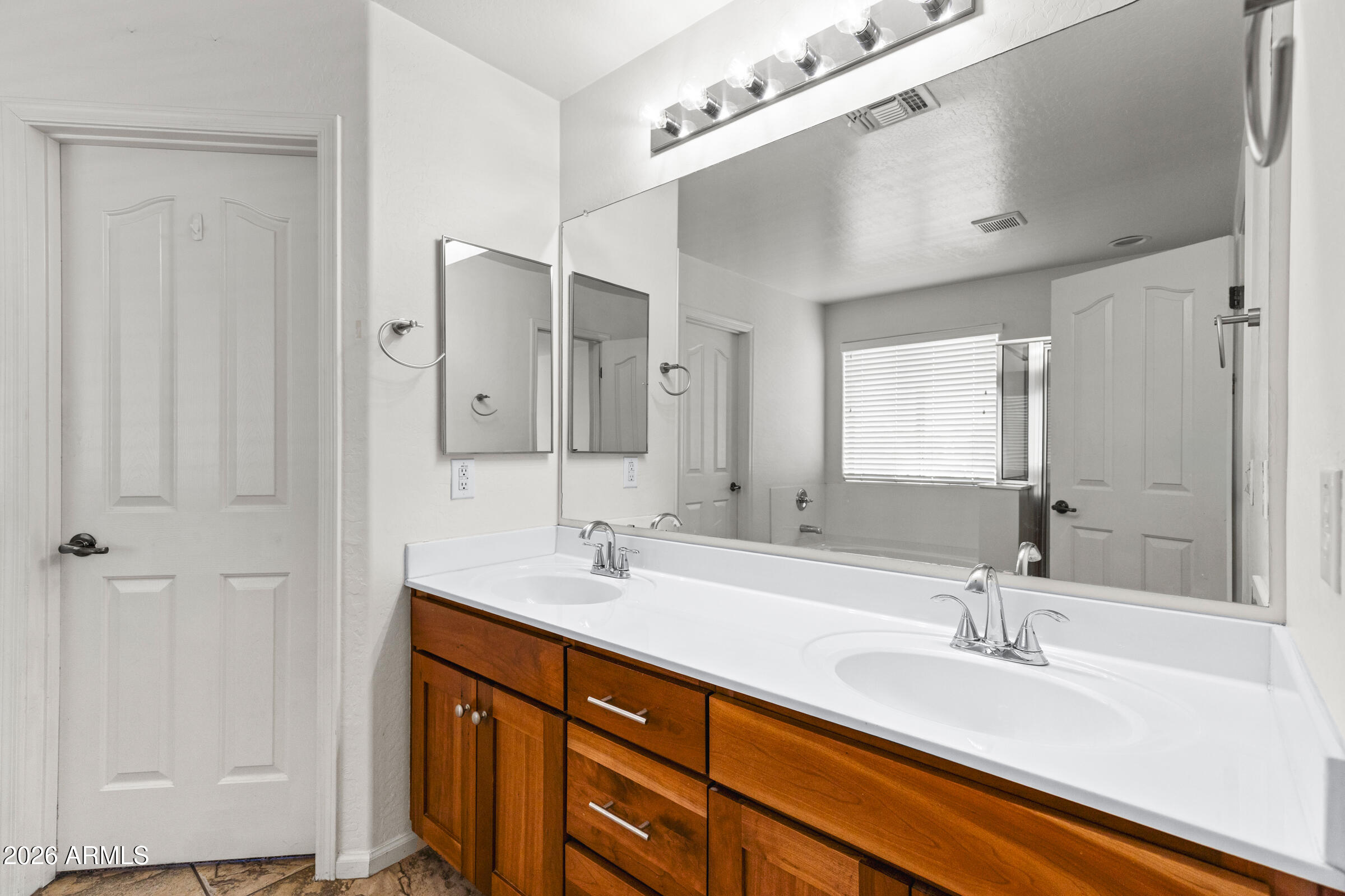3029 East Franklin Avenue Gilbert, AZ 85295 - Photo 20 of 38 a bathroom with a double vanity sink a mirror and a shower
