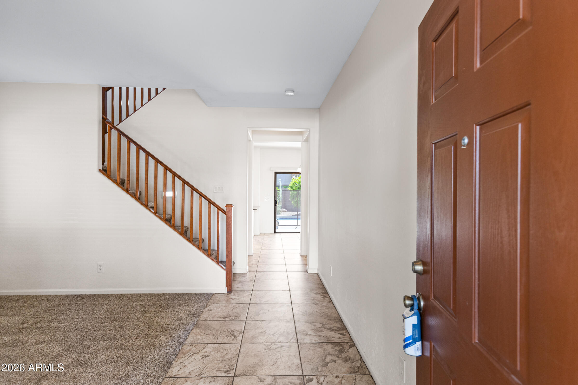 3029 East Franklin Avenue Gilbert, AZ 85295 - Photo 4 of 38 a view of a hallway with wooden floor and staircase