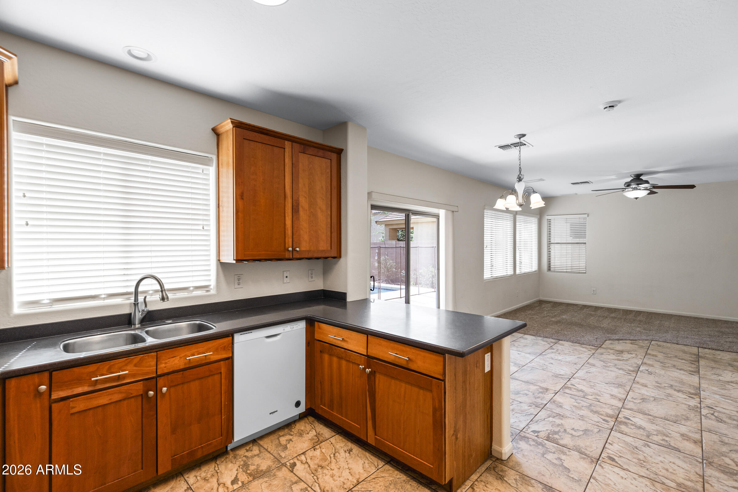 3029 East Franklin Avenue Gilbert, AZ 85295 - Photo 8 of 38 a kitchen with stainless steel appliances granite countertop a sink stove and cabinets