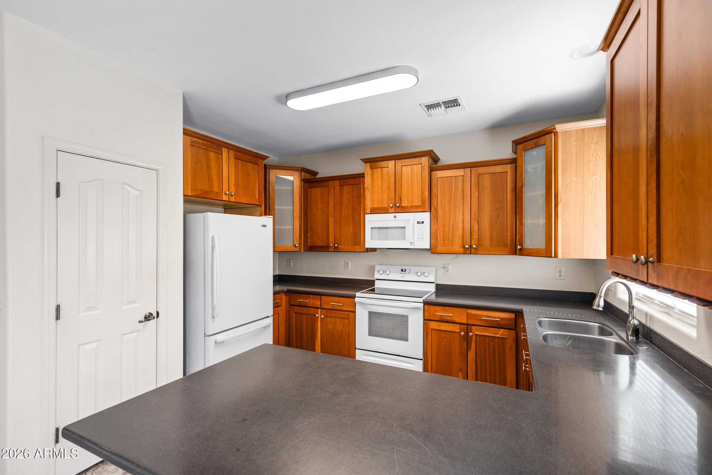 3029 East Franklin Avenue Gilbert, AZ 85295 - Photo 9 of 38 a kitchen with stainless steel appliances granite countertop a sink stove and refrigerator