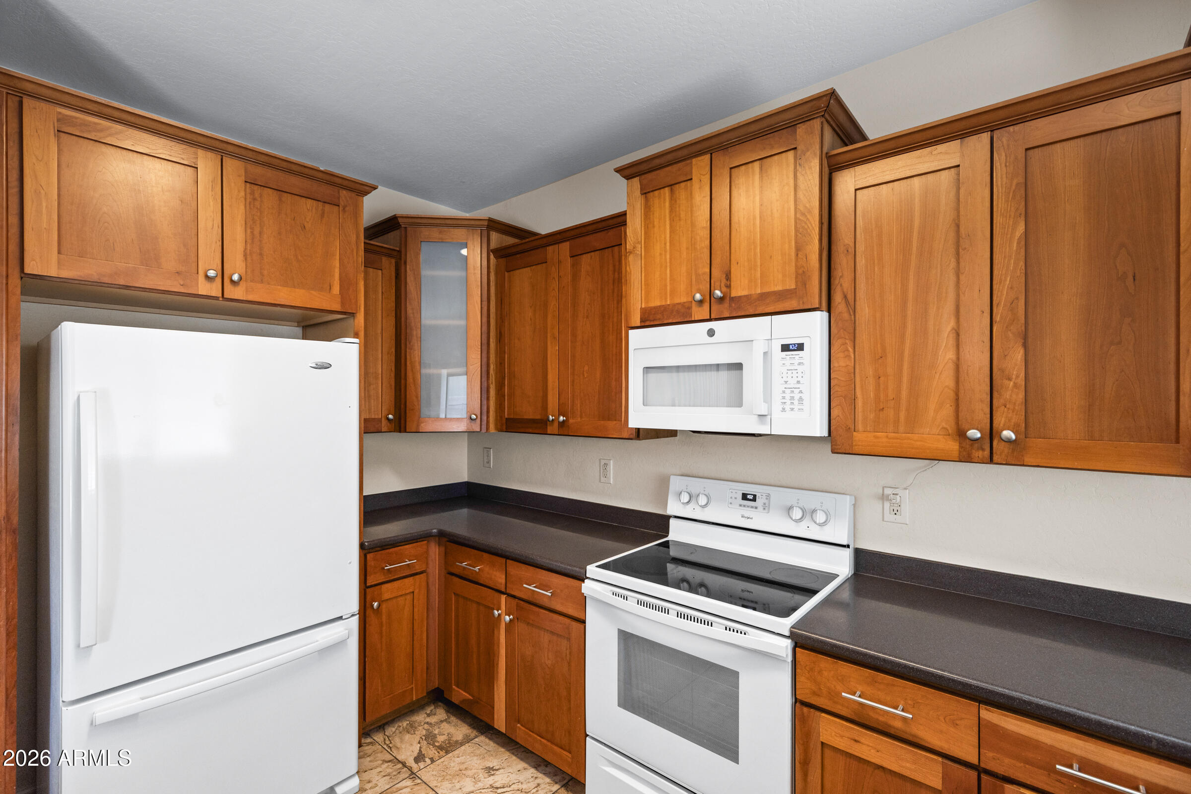 3029 East Franklin Avenue Gilbert, AZ 85295 - Photo 10 of 38 a kitchen with granite countertop cabinets and refrigerator