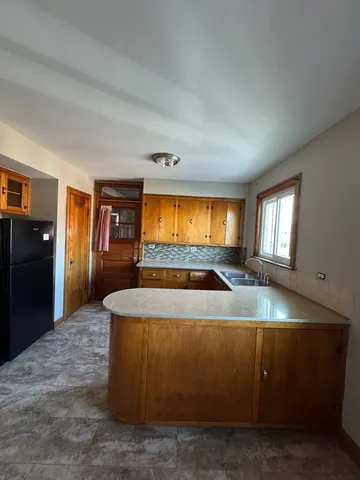 a view of kitchen with wooden floor