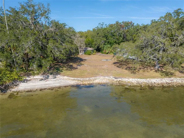 a view of a yard with a table & chairs