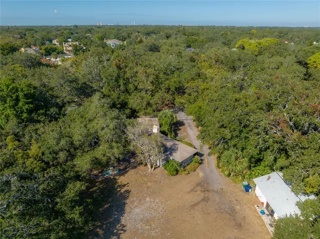 an aerial view of a houses with a yard