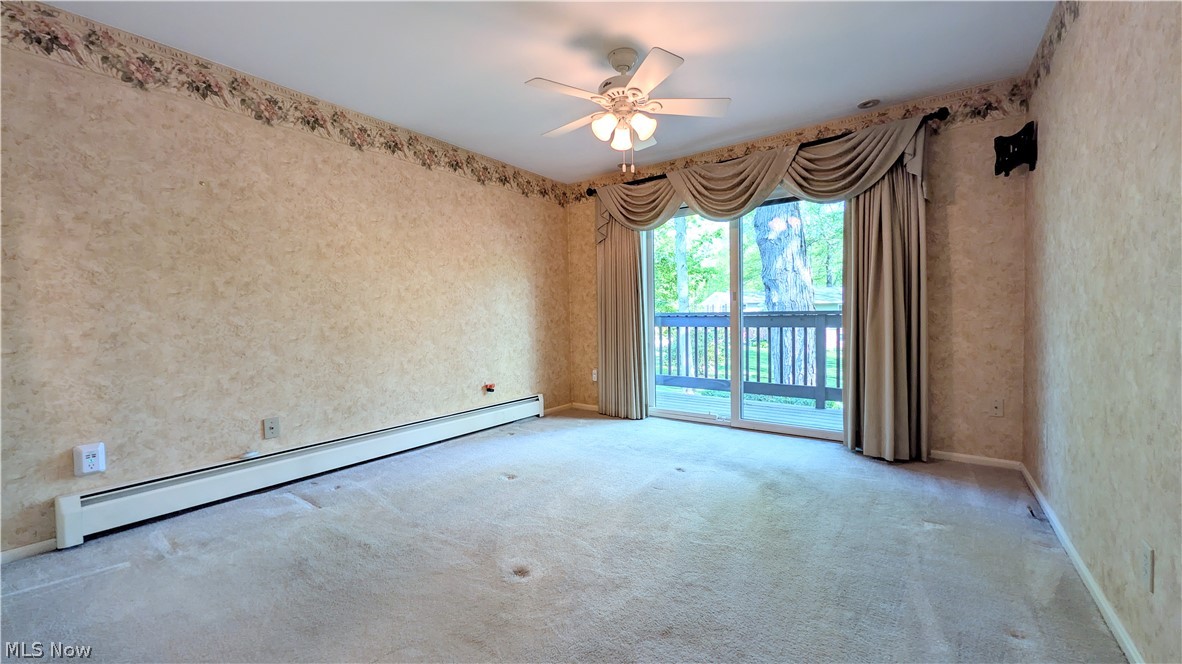 6409 Old Woods Road Ashtabula, OH 44004 - Photo 19 of 43 Spacious room with light-colored carpeting and patterned wallpaper