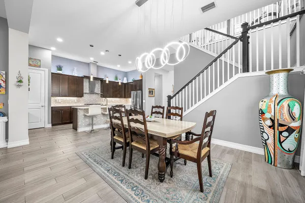 a view of a dining room with furniture and wooden floor