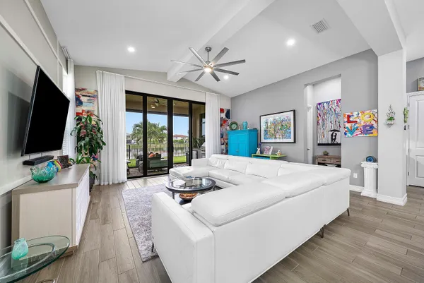 a spacious bedroom with a bed a couch and a flat screen tv