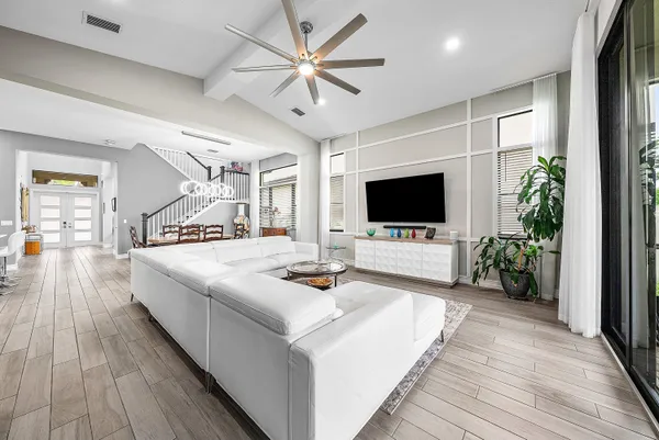 a bedroom with a large bed and a flat tv screen