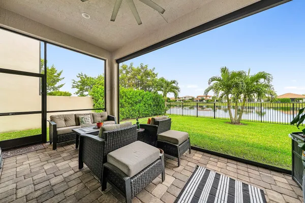 a front view of a house with a yard and outdoor seating