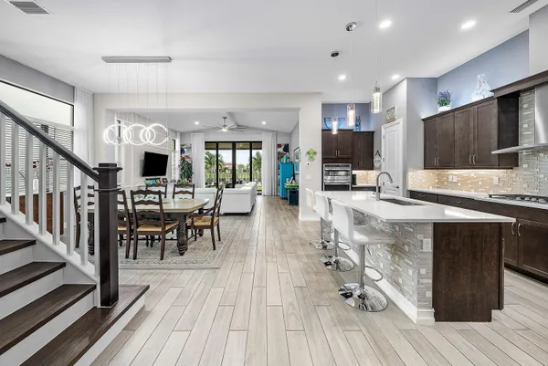 a open kitchen with stainless steel appliances granite countertop a stove and cabinets with wooden floor