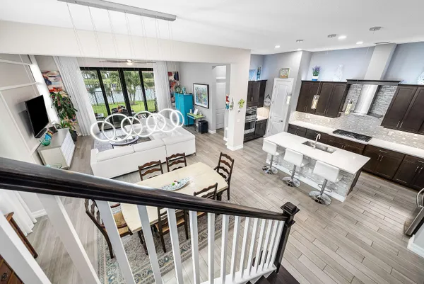 a view of a living room and dining room with wooden floor