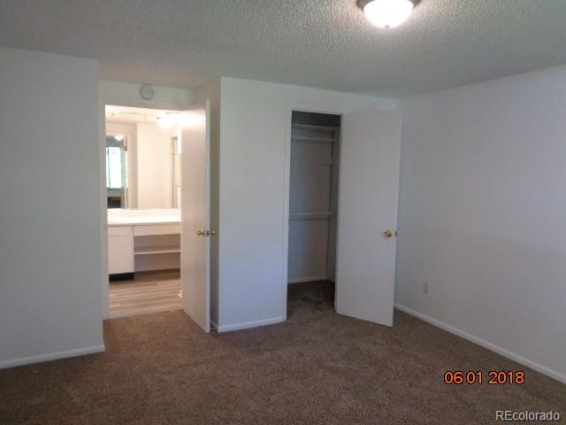 1302 South Parker Road, Unit 216 Denver, CO 80231 - Photo 4 of 13 a view of a room with a bench and closet