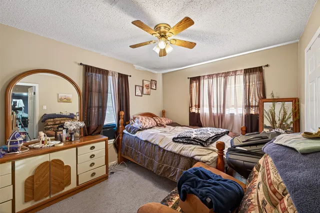 a bedroom with bed and window