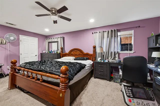 a bedroom with bed chair and window