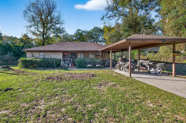 a view of a patio with table and chairs under an umbrella