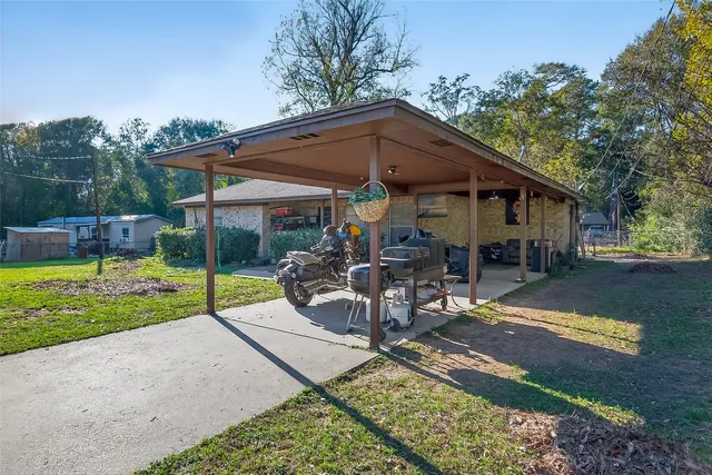 a view of a house with backyard porch and sitting area