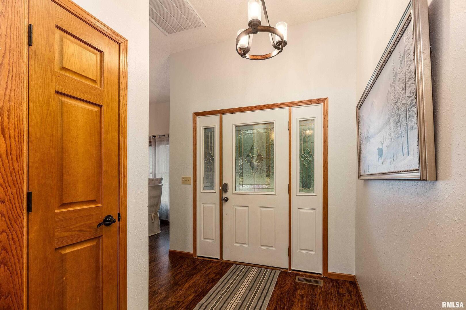 186 Bonnie Brae Road Carbondale, IL 62901 - Photo 5 of 47 a view of a hallway with wooden floor and chandelier