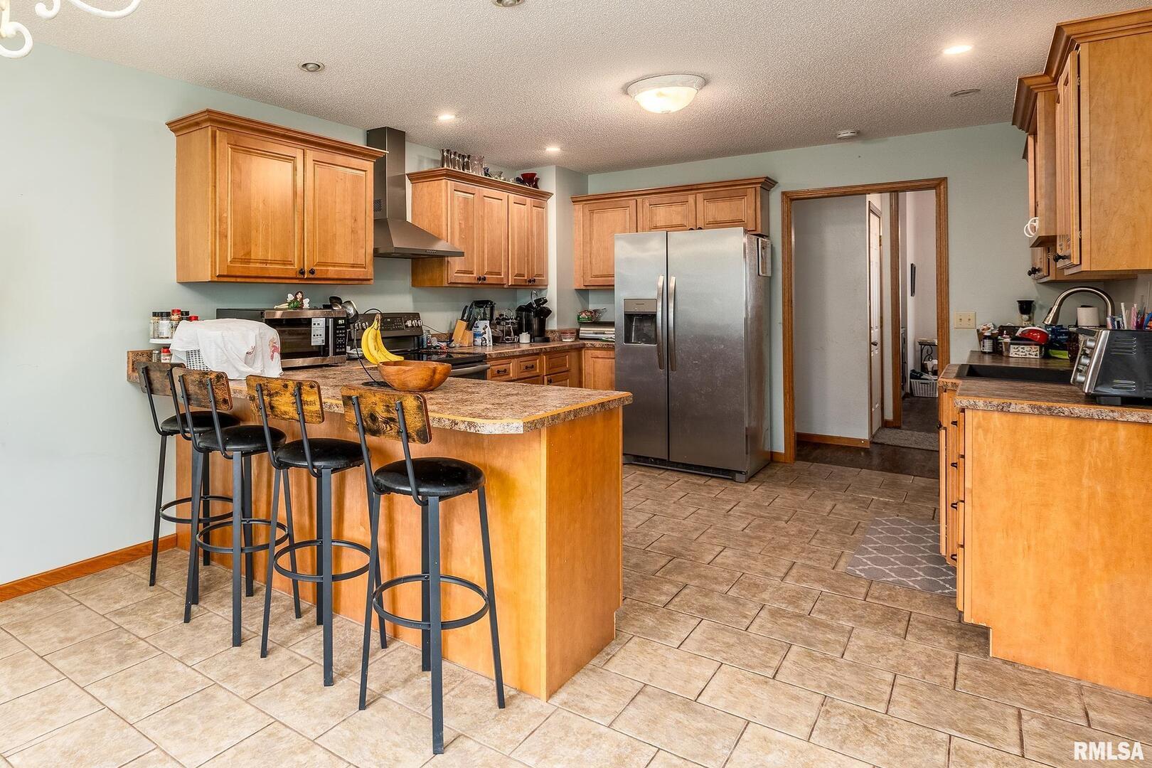 186 Bonnie Brae Road Carbondale, IL 62901 - Photo 9 of 47 a kitchen with stainless steel appliances granite countertop a stove a refrigerator a sink a dining table and chairs with white cabinets