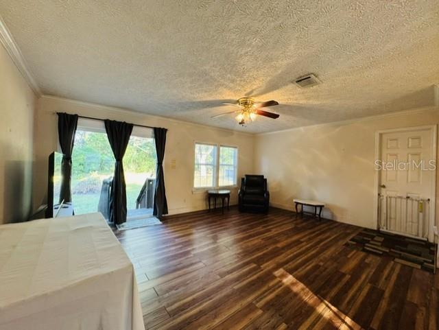 11817 Southwest 58th Street Webster, FL 33597 - Photo 3 of 46 wooden floor in an empty room with a window